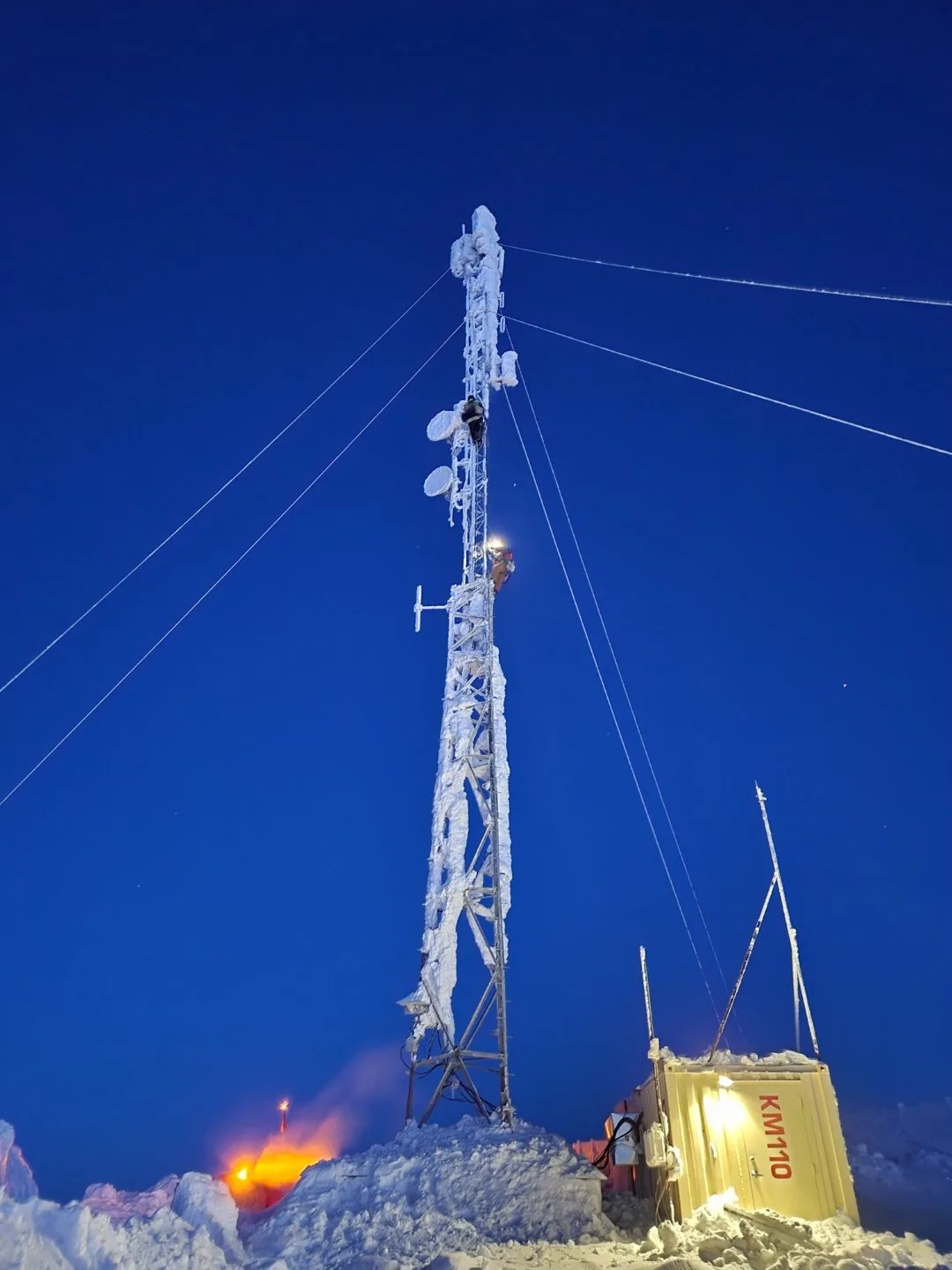 Ice-encrusted lattice tower at dusk, Arctic site